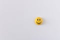 Funny plastic smiley face on a light background. The concept of a positive mood