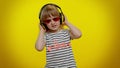 Funny playful blonde child kid listening music via headphones dancing disco fooling having fun party Royalty Free Stock Photo