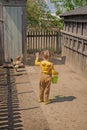 Funny playful girl has fed the chickens and waves goodbye to friends Royalty Free Stock Photo