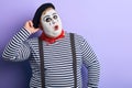 Funny plump mime scratching his head and looking at the camera Royalty Free Stock Photo