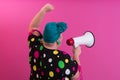 Funny plus size woman woman girl posing on pastel pink wall background studio portrait. People sincere emotions