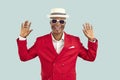 Funny portrait of African American man in red suit, white summer hat and cool sunglasses Royalty Free Stock Photo