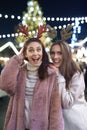 Funny portrait of friends wearing deer hairband