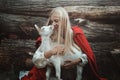 Funny portrait of blond woman and her goat Royalty Free Stock Photo