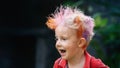 Funny portrait of happy hipster boy with messy colorful hair Royalty Free Stock Photo