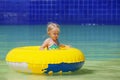 Funny portrait of cheerful baby girl swimming in water park Royalty Free Stock Photo