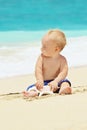 Funny portrait of child playing with sea shell on beach Royalty Free Stock Photo