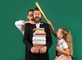Funny portrait of comic father tutor and crazy students schoolkids on green blackboard background. Bad teacher.