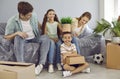 Funny portrait of happy cheerful family in their new house or apartment on moving day Royalty Free Stock Photo