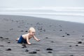 Happy dirty child having fun on black sand beach Royalty Free Stock Photo