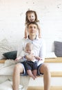 Portrait of a happy young father with a baby son and little daughter at home Royalty Free Stock Photo