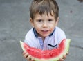 Funny portrait of an incredibly beautiful boy, eating watermelon, healthy fruit snack, Royalty Free Stock Photo