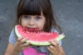 Funny portrait of an incredibly beautiful little girl blue eyes, eating watermelon, healthy fruit snack Royalty Free Stock Photo