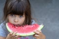 Funny portrait of an incredibly beautiful little girl blue eyes, eating watermelon, healthy fruit snack Royalty Free Stock Photo