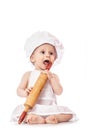 Funny portrait infant cook baby portrait wearing apron and chef hat with dough rolling pin, isolated on a white background