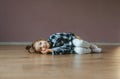 Funny portrait of lying cute little girl on a floor indoors Royalty Free Stock Photo