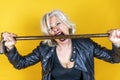 Funny portrait of mature woman. Beautiful lady have fun as a rock star dressed in leather Royalty Free Stock Photo