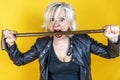 Funny portrait of mature woman. Beautiful lady have fun as a rock star dressed in leather Royalty Free Stock Photo