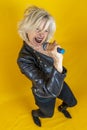Funny portrait of mature woman. Beautiful lady have fun as a rock star dressed in leather Royalty Free Stock Photo