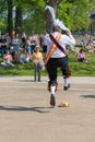 Funny portrait of morris dancer jumping on to his straw hat