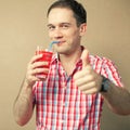 Funny portrait of a smiling handsome blue-eyed hipster boy drink