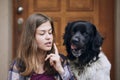Funny portrait of teenager girl sitting with her Czech mountain dog