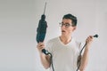 Funny portrait upset craftsmen. Nerd is wearing glasses.. Does not know how to use a drill Royalty Free Stock Photo