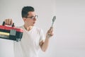 Funny portrait upset craftsmen. Nerd is wearing glasses.. Does not know how to use tools for repair Royalty Free Stock Photo