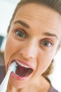 Funny portrait of woman intensively brushing teeth