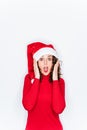 A funny portrait of a woman wearing a Santa hat in Christmas. She is looking at the camera with a surprised face. Christmas Royalty Free Stock Photo