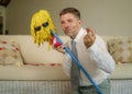 Funny portrait of young weird crazy and happy man holding mop with sunglasses as if it was his fiance kneeling and proposing marri Royalty Free Stock Photo