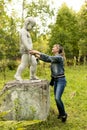 Funny posing of a girl with a sculpture, entertainment