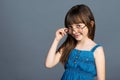 A funny positive little girl put on adult glasses on her face and laughs merrily and smiles with fallen milk teeth Royalty Free Stock Photo