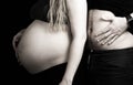 Funny pregnant couple, daddy compares his belly to his wife`s pregnant stomach Royalty Free Stock Photo