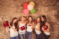 Funny pretty girls holding birthday cake, balloons and presents