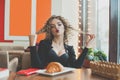Funny pretty young woman in cafeteria Royalty Free Stock Photo