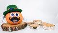 a funny pumpkin with a hat on its head and a mustache stands on a round wooden podium on a light background. concepts Royalty Free Stock Photo