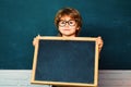 Funny pupil. Elementary school and education. Preschooler. Blackboard copy space. Little children at school lesson Royalty Free Stock Photo