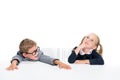 Funny pupils sitting at desk