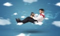 Funny racedriver young man driving between clouds concept Royalty Free Stock Photo