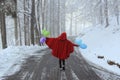 Funny red hooded woman with colorful balloons