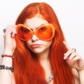 Funny redhair woman in big orange glasses