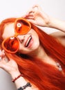 Funny redhair woman in big orange glasses