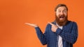 Funny Redhaired Man Pointing Finger At His Open Palm, Studio Royalty Free Stock Photo