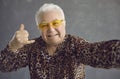 Funny rich senior man in trendy glasses and leopard patterned shirt saying Call Me Royalty Free Stock Photo