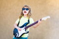 Funny rock child with guitar. Little boy in sunglasses. Kids music concept. Rock and roll guitar. Boy guitarist. Royalty Free Stock Photo