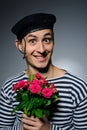 Funny romantic sailor man holding rose flowers