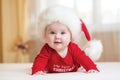 Funny Santa baby girl lying on bed Royalty Free Stock Photo