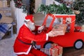 Funny Santa Claus reading children desires on tablet and checkin