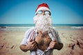 Funny santa claus super hero beach summer christmas Royalty Free Stock Photo